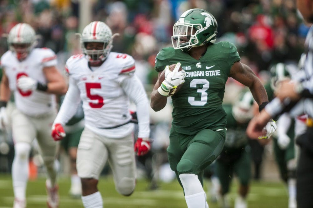 Sophomore running back LJ Scott (3) receives a 64 yard  pass down the field for the first touchdown of the game in the first quarter of the game against Ohio State on Nov. 19, 2016 at Spartan Stadium. 