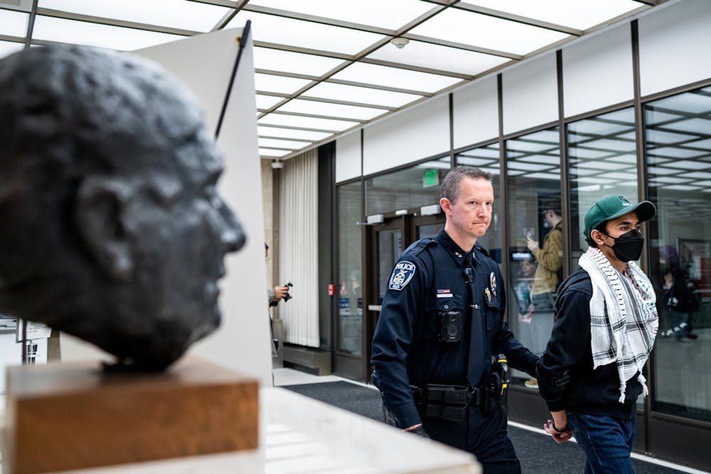<p>Michigan State University Deputy Chief Chris Rozman arrests a protestor in the lobby of the Hannah Administration Building in East Lansing, Michigan on April 11, 2025. Members of MSU Sunrise and the Hurriya Coalition protested in the lobby, 19 protestors were arrested after multiple warnings from the police.</p>