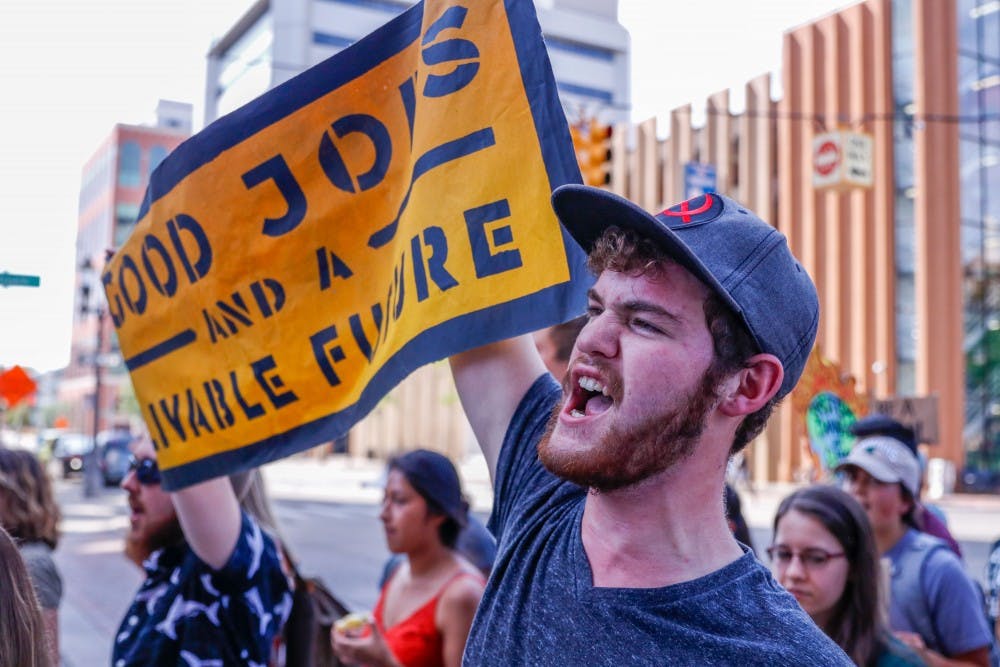 <p>A man joins in a chant calling for the end of fossil fuels at the Global Climate Strike at the Capitol building in Lansing Sep. 20, 2019. The strike was part of a global movement started by young climate activist Greta Thunberg, that comes three days before the UN Climate Summit in NYC. </p>