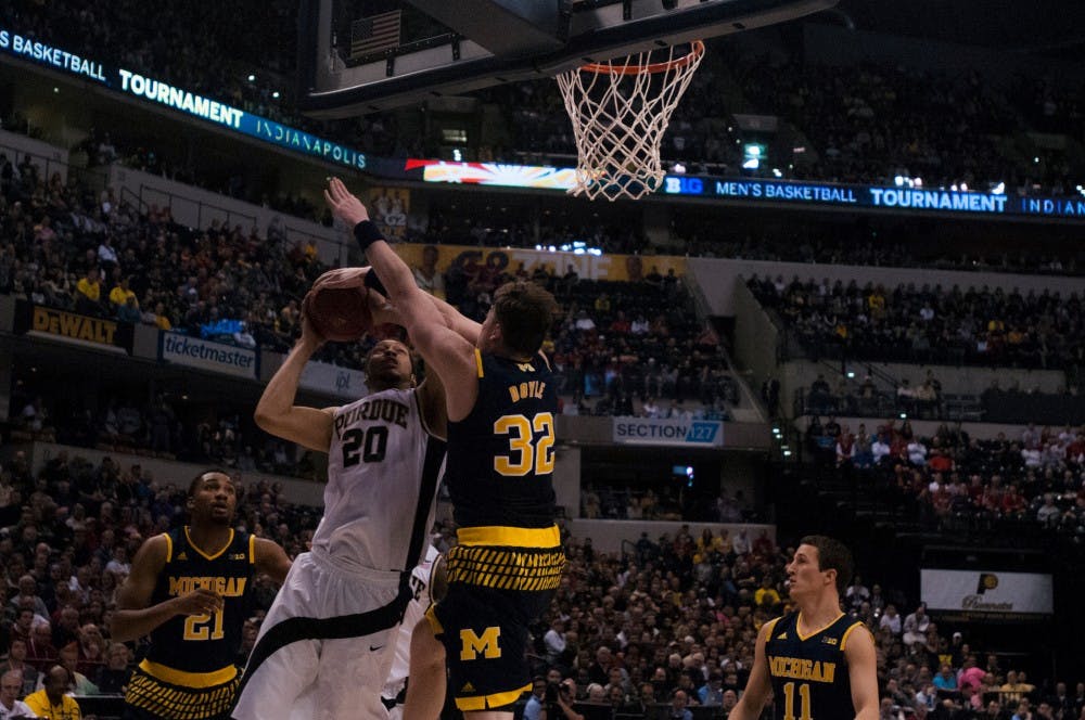 Purdue center A.J Hammons shoots a basket over Michigan forward Ricky Doyle during the first half of the game on March 12, 2016 at Bankers Life Fieldhouse in Indianapolis, Indiana. The Boilermakers defeated the Wolverines, 76-59.  