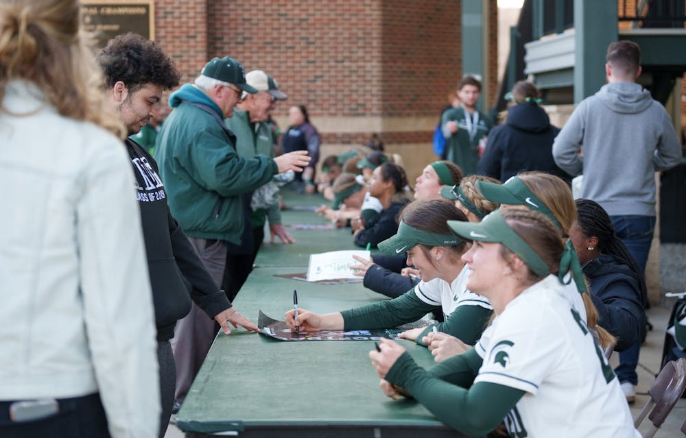 <p>Michigan State softball players stay after the game to sign posters and meet the fans. Spartans lost 5-4 against Nebraska, on April 10, 2022.</p>