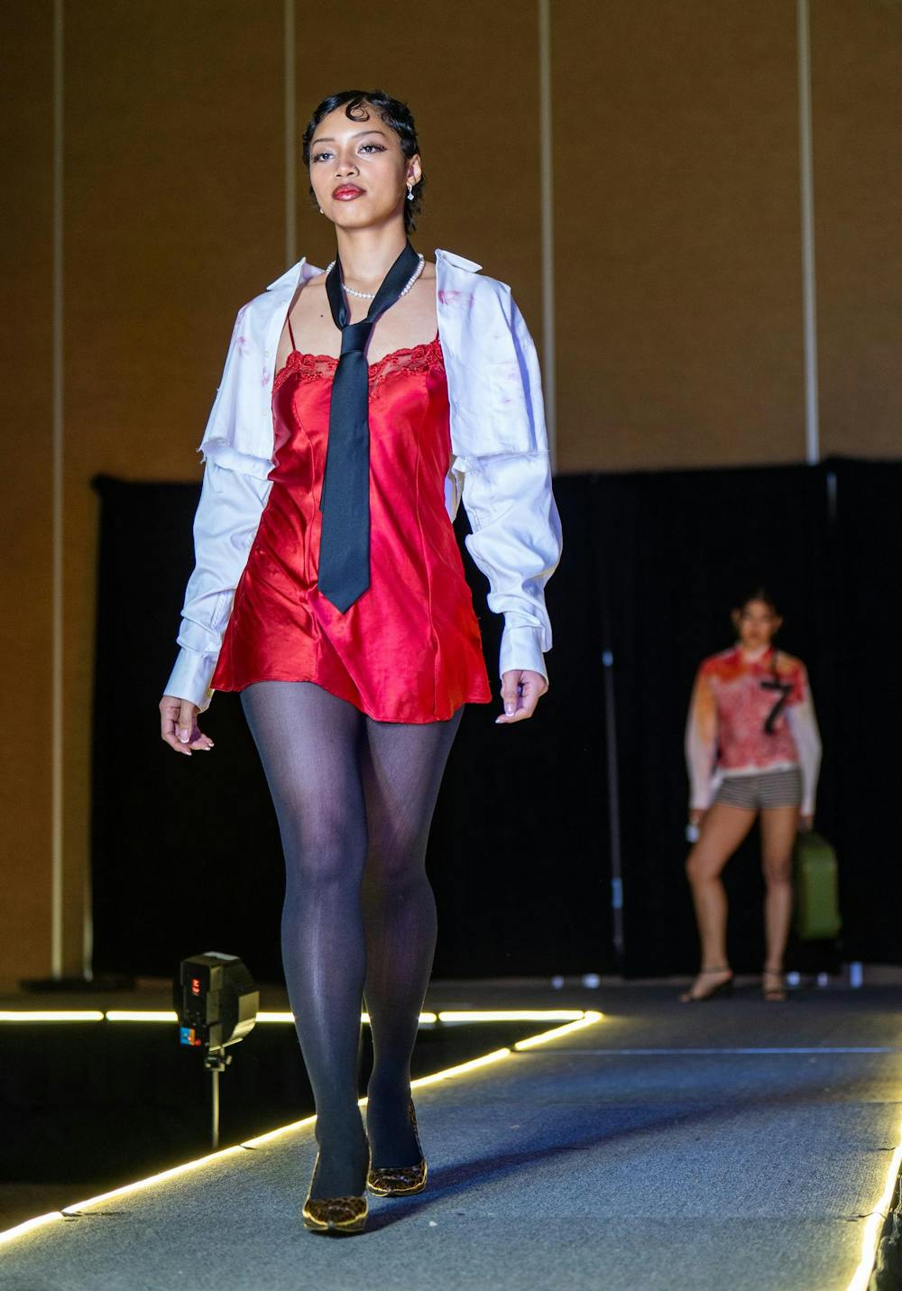 A model poses during N Crowd magazine’s fall fashion show at The Lansing Center on Dec. 8, 2024. N Crowd, a fashion magazine and non-profit organization for creatives at MSU, holds a fashion show every semester.
