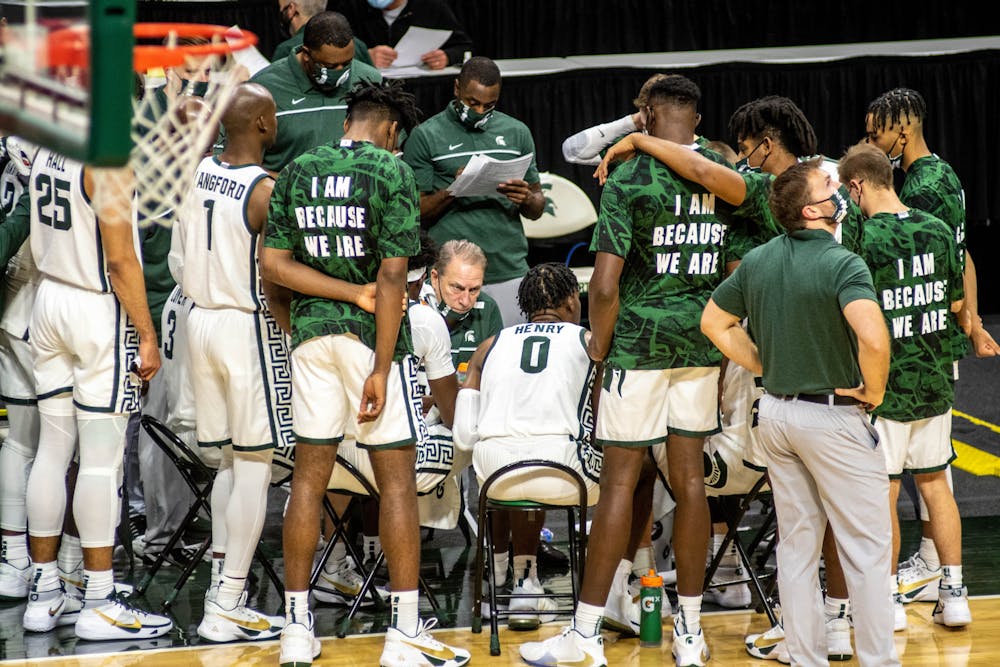 <p>The Spartans listen to coach Tom Izzo during a timeout during the game against Eastern Michigan on Nov. 25, 2020, at the Breslin Center. The Spartans defeated the Eagles, 83-67.</p>
