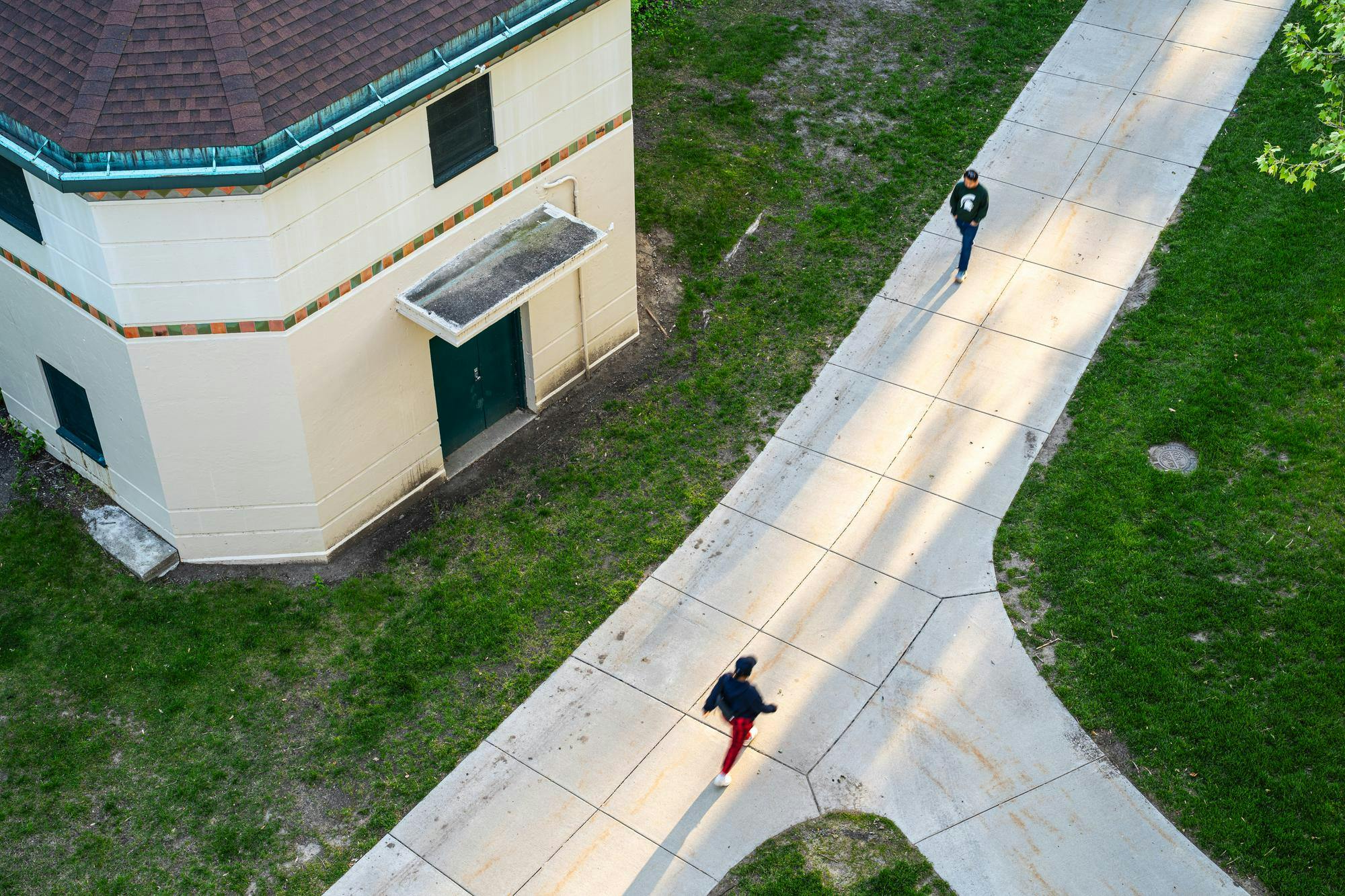 A look down from Parking Ramp #2 onto the river trail on Auditorium Road on Michigan State University's campus in East Lansing, Michigan on May 26, 2025. 