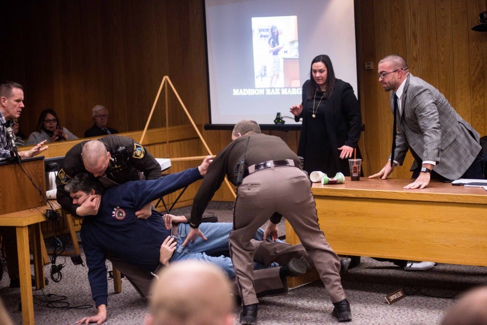 Randal Margraves, father of Madison Rae Margraves and Lauren Margraves, has to be restrained after attempting to attack Nassar on the second day of sentencing for Larry Nassar on Feb. 2, 2018, in the Eaton County courtroom. Nassar faces three counts of criminal sexual conduct in Eaton. (Annie Barker | State News)