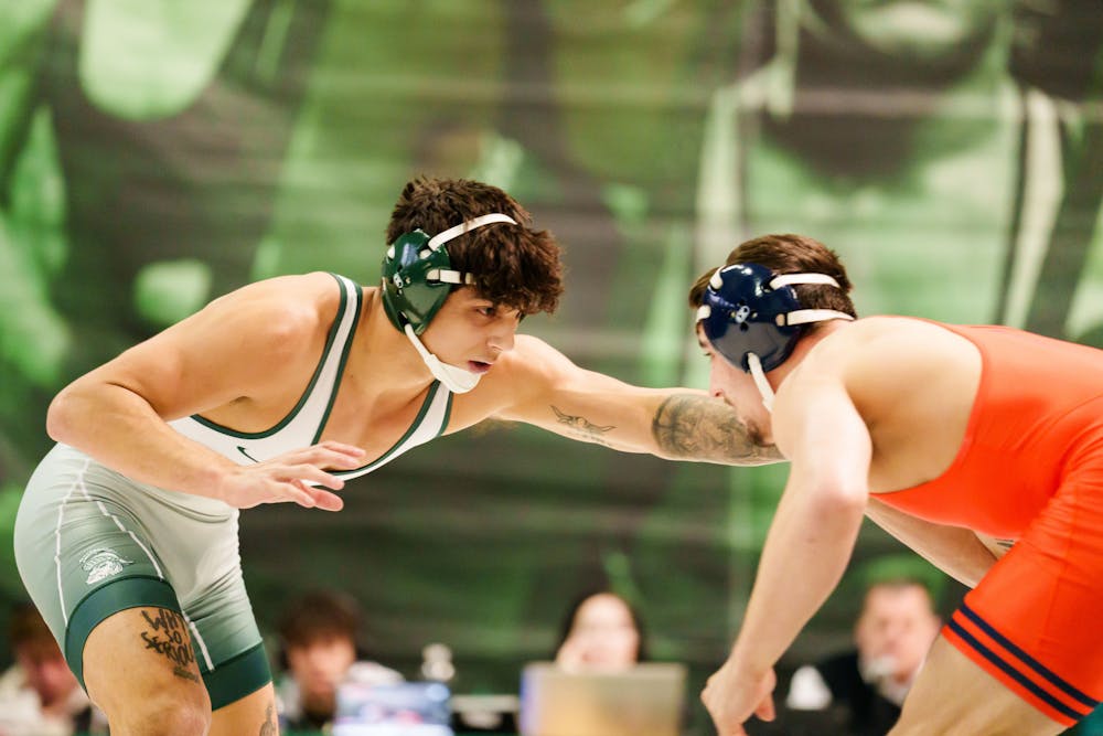<p>Junior Chase Saldate feels out his opponent during a meet against the University of Illinois, held at Jenison Fieldhouse on Feb. 5, 2023. The Spartans fell to the Illini 17-16.</p>