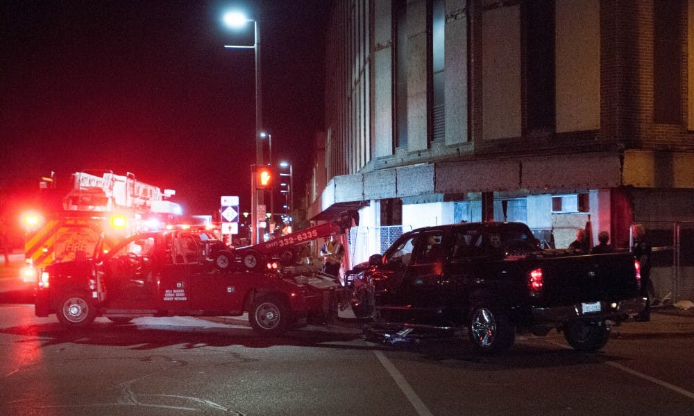 The East Lansing Fire Department and tow truck is pictured at the scene after a Dodge truck crashed into a building on Sep. 27, 2017 at the corner of Grand River Ave. and Abbott.