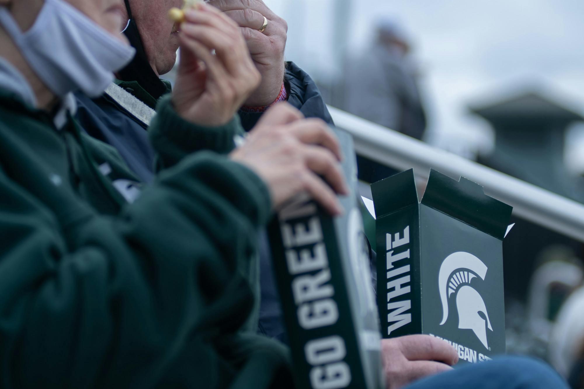 Michigan State fans eating popcorn during Michigan State's game against Purdue on April 12, 2021 at McLane Stadium at Kob's Field in East Lansing. 