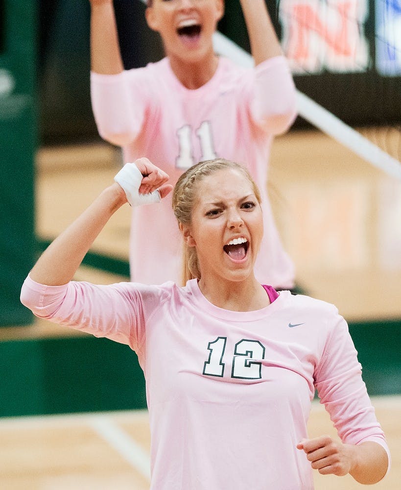 <p>Freshman setter Rachel Minarick celebrates after a point Oct. 11, 2014, during the game against Iowa at Jenison Field House. The Spartans defeated the Hawkeyes, 3-0. Jessalyn Tamez/The State News</p>