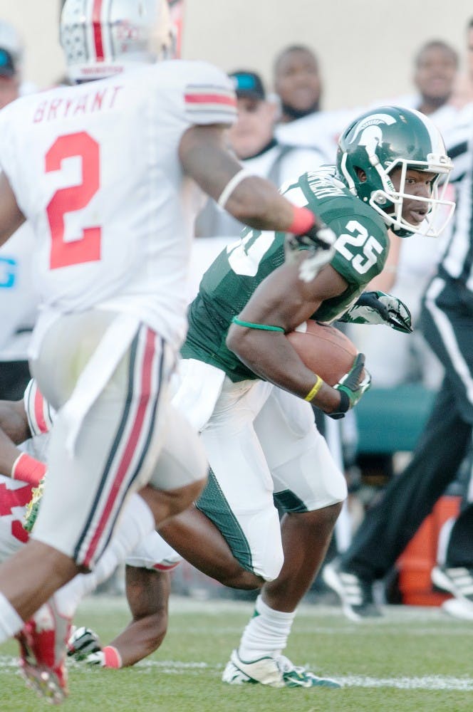 	<p>Sophomore wide receiver Keith Mumphery runs with the ball right before scoring during Saturday&#8217;s game. Natalie Kolb/The State News</p>