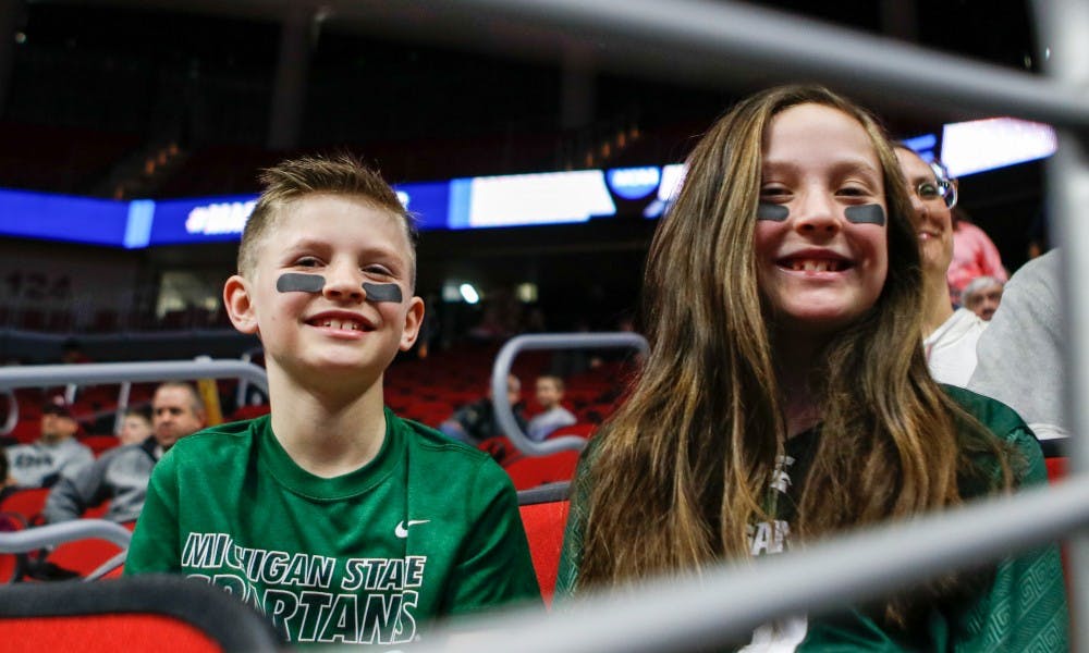 Des Moines resident Drew Hammond, 8, and Katie Hammond, 11, pose for a photo during an open practice at Wells Fargo Arena March 20, 2019.