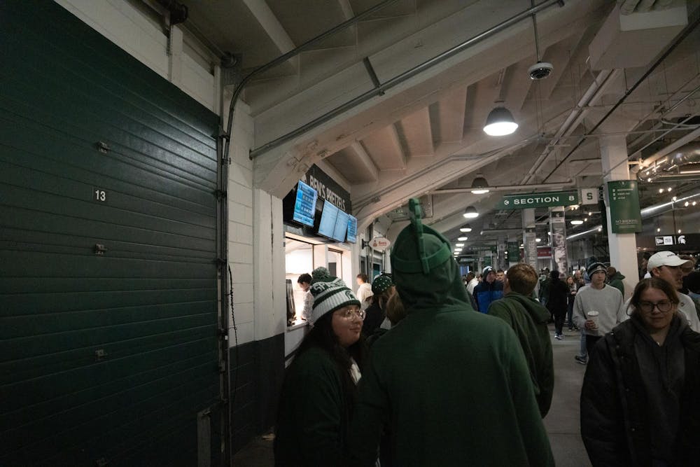 Spectators pack into winding concession lines at Spartan Stadium in East Lansing, Mich., on Saturday, Nov. 16, 2025, leading to extended waits during the game.