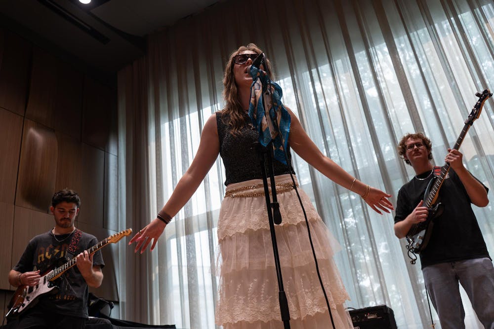 <p>Luke Karsten, Alina Morse and Kade Ringer (from left) practice for their band, Roxy Riot, at the MSU Music Building in East Lansing, Mich., on July 17, 2026.</p>