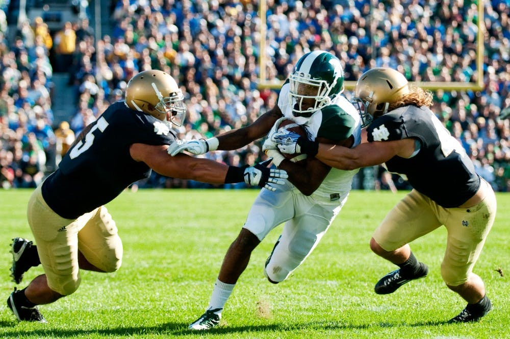 Senior wide receiver B.J. Cunningham weaves his way through the Notre Dame defense. Cunningham had 158 yards on 12 catches. The Spartans lost to the Fighting Irish, 31-13, on Saturday afternoon at Notre Dame Stadium in South Bend, Ind. Josh Radtke/The State News