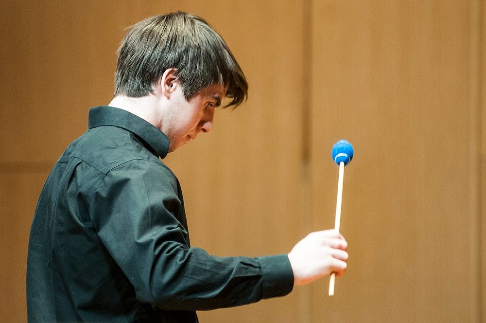 <p>Percussion performance freshman Austin Ridoux performs as part of "Latin IS America" on April 9, 2014, at Cook Recital Hall in the Music Building. Students performed for a full house as part of the first showing of the series. Danyelle Morrow/The State News</p>