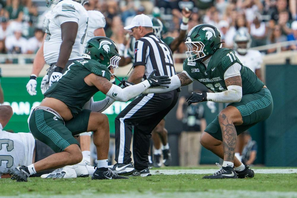 <p>Kenny Soares Jr. (1) and Anelu Lafaele (11) celebrate after taking down Eastern Michigan's quarterback, (1) Noah Kim, deep in the backfield in Spartan Stadium in East Lansing, Mich., on Sept. 12, 2026.</p>
