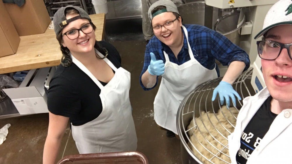 <p>Former MSU student Nikki Touchinski (middle) poses for a picture while she worked at MSU Bakers. Touchinski died of a catastrophic medical event on March 17, 2018. Photo courtesy of Carole Touchinski.</p>