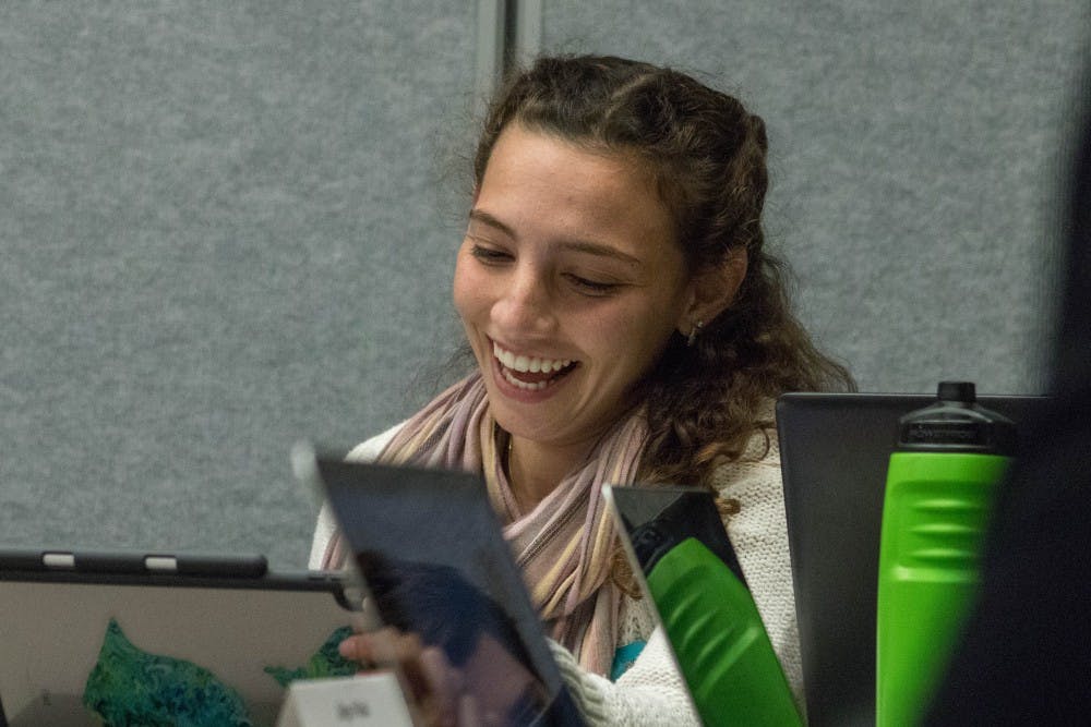 President of the Associated Students of Michigan State University Katherine "Cookie" Rifiotis laughs during the ASMSU meeting at the Student Service Building on Oct. 25, 2018.