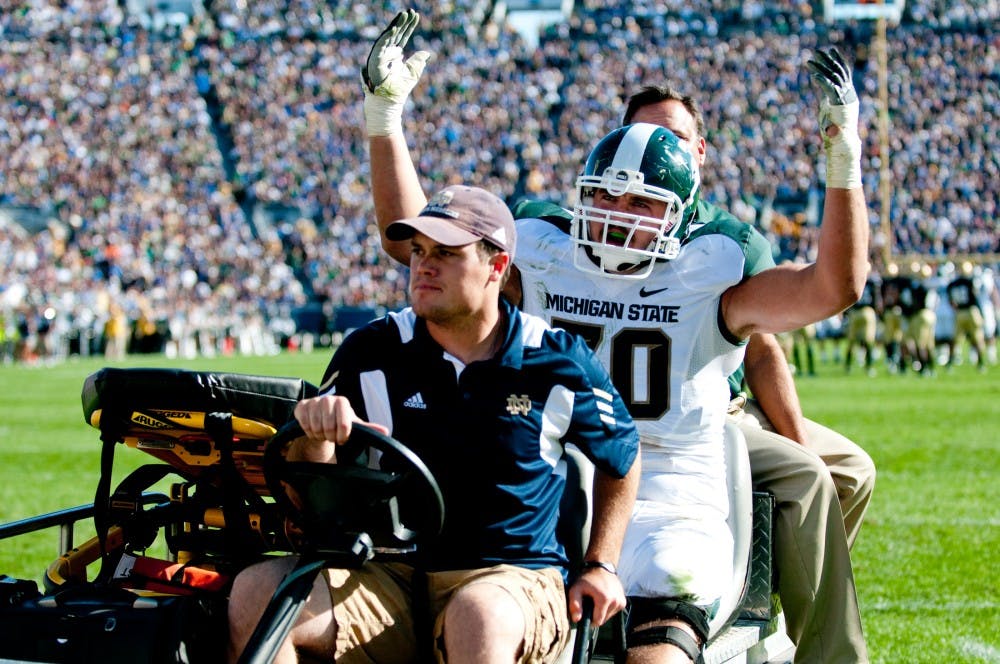 Redshirt freshman offensive tackle Skyler Burkland leaves the game after an injury in the first half. The Spartans lost to the Fighting Irish, 31-13, on Saturday afternoon at Notre Dame Stadium in South Bend, Ind. Josh Radtke/The State News