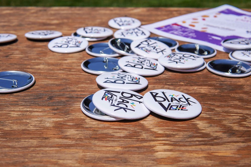 <p>Free &quot;Black the Vote&quot; pins sit on a table during the Black Lives Matter protest at the Michigan State Capitol on June 29, 2020.</p>