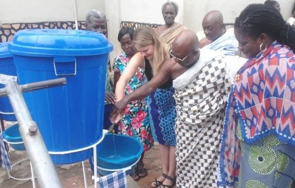 <p>Biochemistry and molecular biology senior Sarah Tresedder and the chief of Larteh, Ghana,&nbsp;test the hand washing stations. Courtesy of Sarah Tresedder.</p>