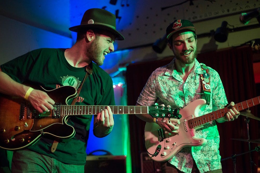 <p>Guitarist Chris Bota, left, and guitarist and vocals Isaac Berkowitz, right, of Desmond Jones perform Mar. 20, 2015, at The Avenue, 2021 E Michigan Ave. in Lansing. The concert was held in celebration of the release of their first physical extended play recording. Emily Nagle/The State News</p>