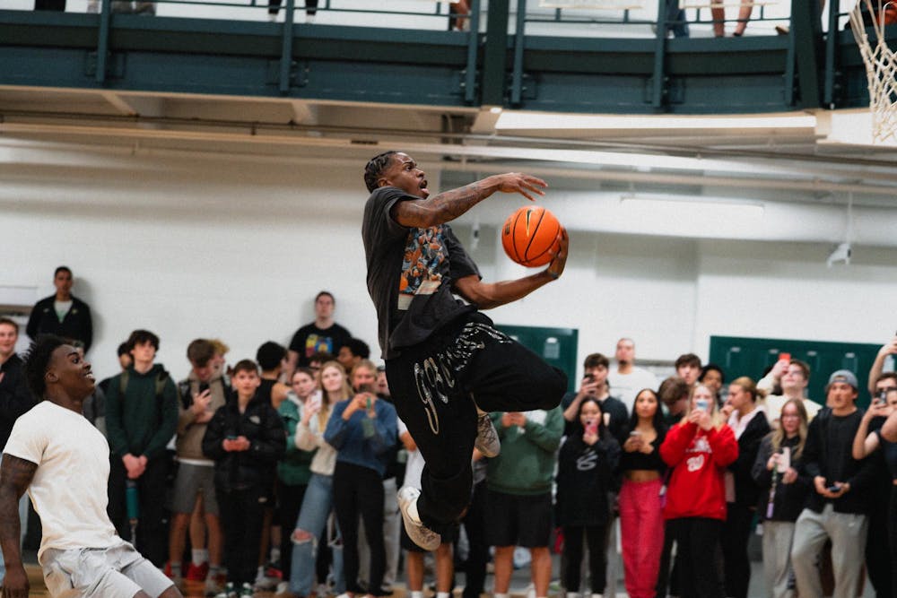 <p>Michigan State sophomore forward Coen Carr dunks the ball at IM East on April 16, 2025. The men's basketball team showed off their skills during pickup runs for students to watch.</p>