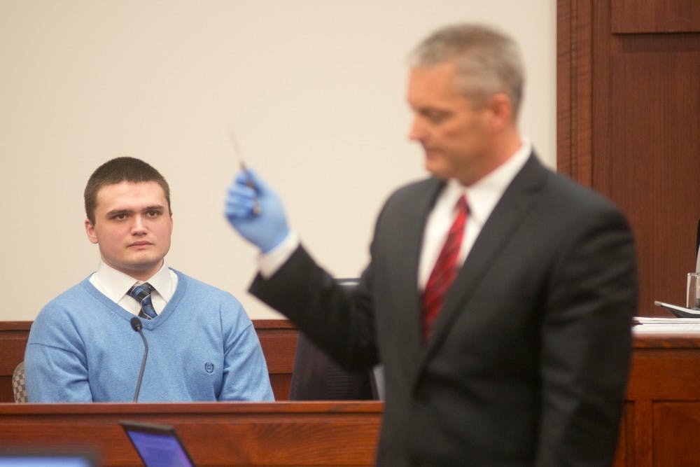 	<p>Alleged murderer Connor McCowan looks at a knife Deputy Chief Assistant Prosecutor John Dewane is holding during his testimony Oct. 11, 2013, at the Ingham County Circuit Court in Lansing. McCowan is accused of fatally stabbing <span class="caps">MSU</span> student Andrew Singler after getting in a fight with him over text messages Feb. 23. Julia Nagy/The State News </p>