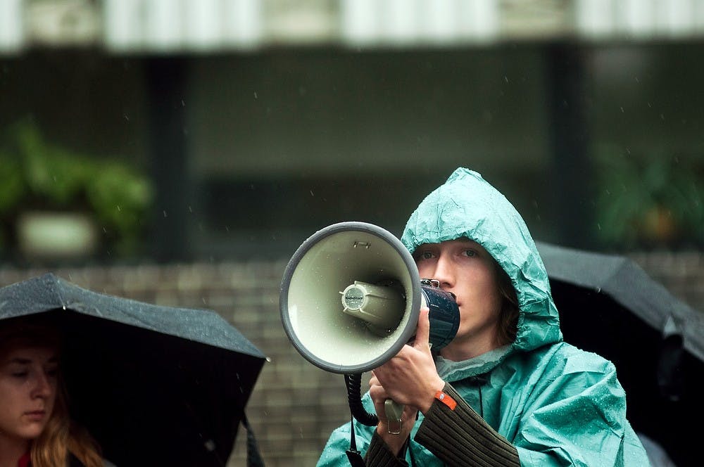 	<p>Social relations and policy sophomore Connor Meston uses a bullhorn during a protest demonstration against the vote on war in Syria, Sept. 9, 2013, in front of the parking structure, behind Bessey Hall. The students stood in the rain to protest the impending vote by congress on whether or not to pursue war in Syria. Danyelle Morrow/The State News</p>