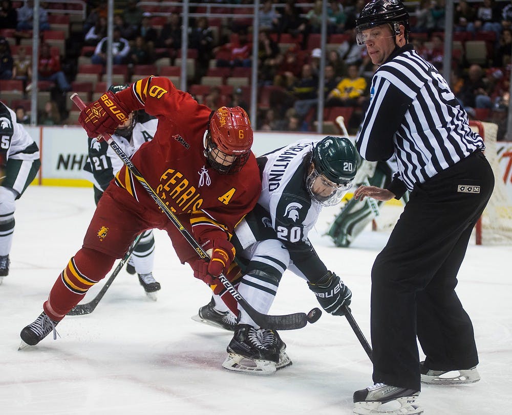 <p>Junior forward Michael Ferrantino faces off against Ferris State forward Kyle Schempp on Dec. 28, 2014, during the 50th Great Lakes Invitational at Joe Louis Arena in Detroit. The Spartans defeated the Bulldogs, 2-0. Danyelle Morrow/The State News</p>