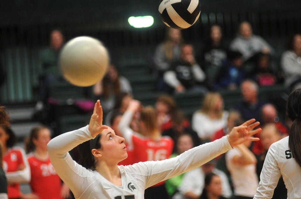 <p>Freshman defensive specialist Marissa Ratzenberger warms up Nov. 22, 2014 before the first match against Rutgers at Jenison Field House. The Spartans defeated the Scarlet Knights 3-0. Dylan Vowell/The State News</p>