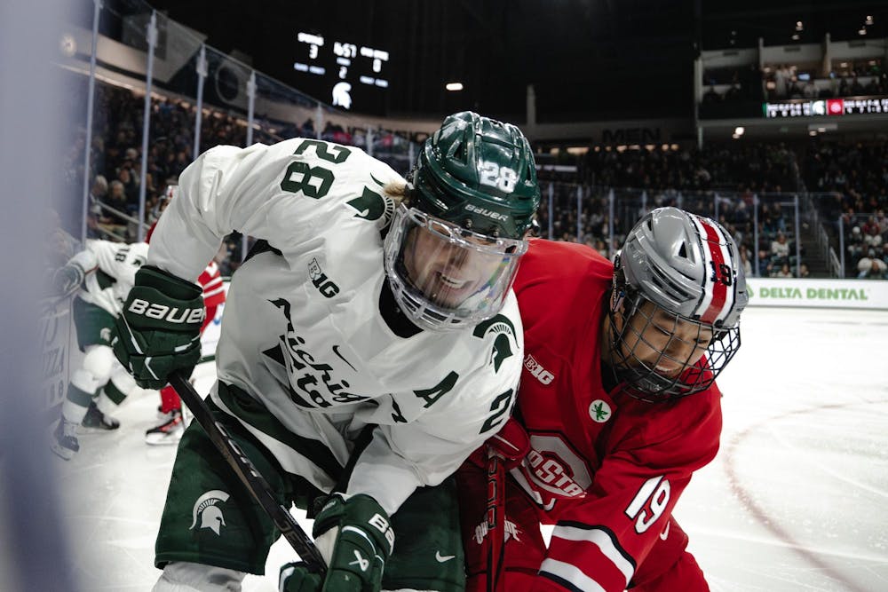 <p>Spartan junior forward Karsen Dorwart (28) battles Buckeye freshman forward James Hong (19) in a game against Ohio State at Munn Ice Arena on Nov. 8, 2024</p>