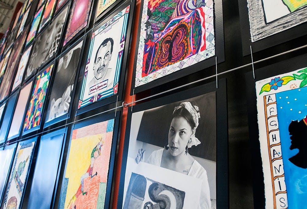 	<p>Pieces of art work hang on a wall Monday, Feb. 25, 2013, at Peckham Inc., 3510 Capital City Blvd., in Lansing. Art@Work, a creative collaboration between Peckham client artists, community artists and <span class="caps">MSU</span> students in the Residential College in the Arts and Humanities was unveiled Saturday, Feb. 23. Adam Toolin/The State News</p>