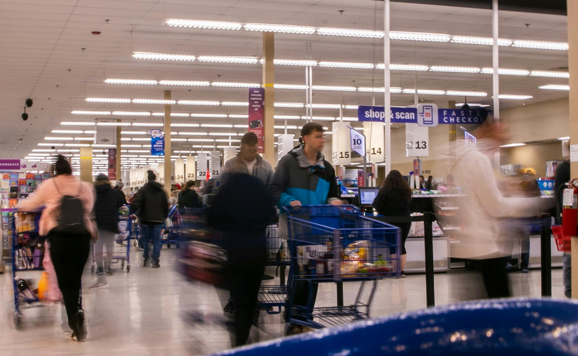 <p>People walk around the checkout aisles at Meijer on March 12, 2020, after MSU canceled classes due to coronavirus.</p>