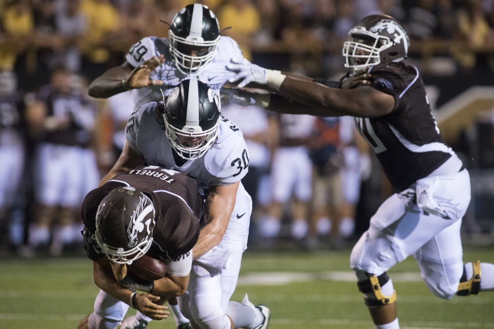 <p>Junior linebacker Riley Bullough sacks Western Michigan quarterback Zach Terrell on during a game against Western Michigan on Sept. 4, 2015 at Waldo Stadium in Kalamazoo, Michigan. The Spartans beat the Broncos, 37-24. Julia Nagy/The State News</p>