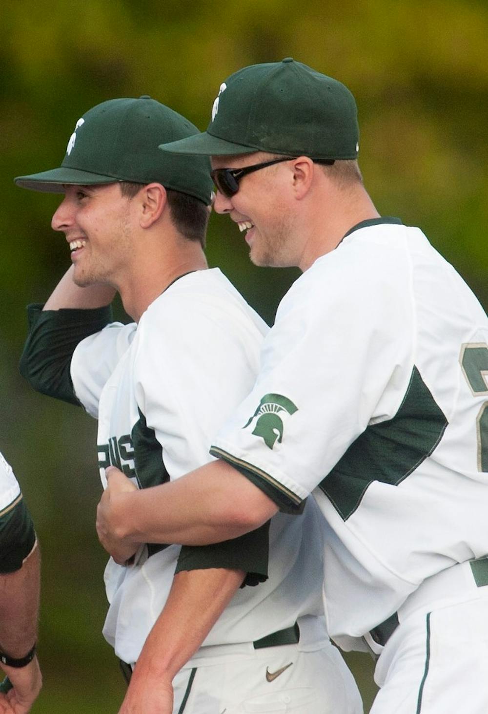 	<p>Senior right-handed pitcher Cody Huge, right, celebrates with senior left-handed pitcher Trey Popp, left, after Popp finished a successful inning to end the game on May 8, 2013, at McLane Baseball Stadium at Old College Field. The Spartans beat Eastern Michigan 6-3. Danyelle Morrow/The State News. State News File Photo</p>