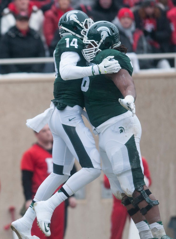 <p>Senior wide receiver Tony Lippett celebrates with junior offensive lineman Donavon Clark after scoring a touchdown Nov. 22, 2014, during the game against Rutgers at Spartan Stadium. The Spartans defeated the Scarlet Knights, 45-3. Aerika Williams/The State News </p>