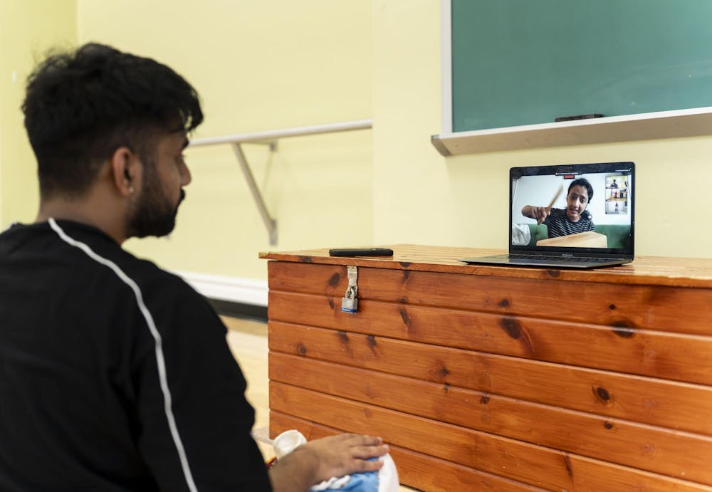 Abhinav Anand watches his dance teacher through zoom in the dance studio in IM Circle in East Lansing, Mich., on Feb. 20, 2026. Because his style of dance is so specific, he started taking classes online with a teacher based in New Jersey. 
