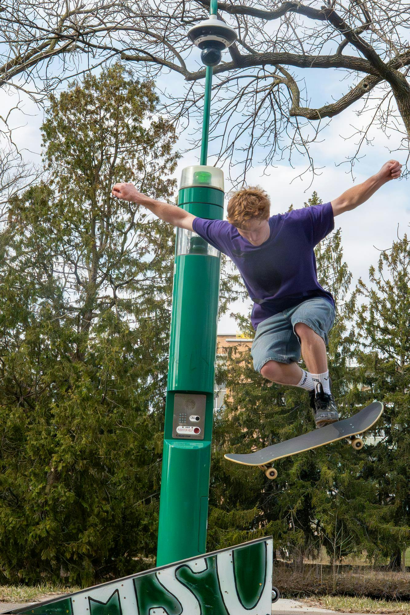 Will Velthoven performs a trick midair during MSU Skate Club outside of Shaw Hall on Michigan State University’s campus in East Lansing, Mich., on March 20, 2026.