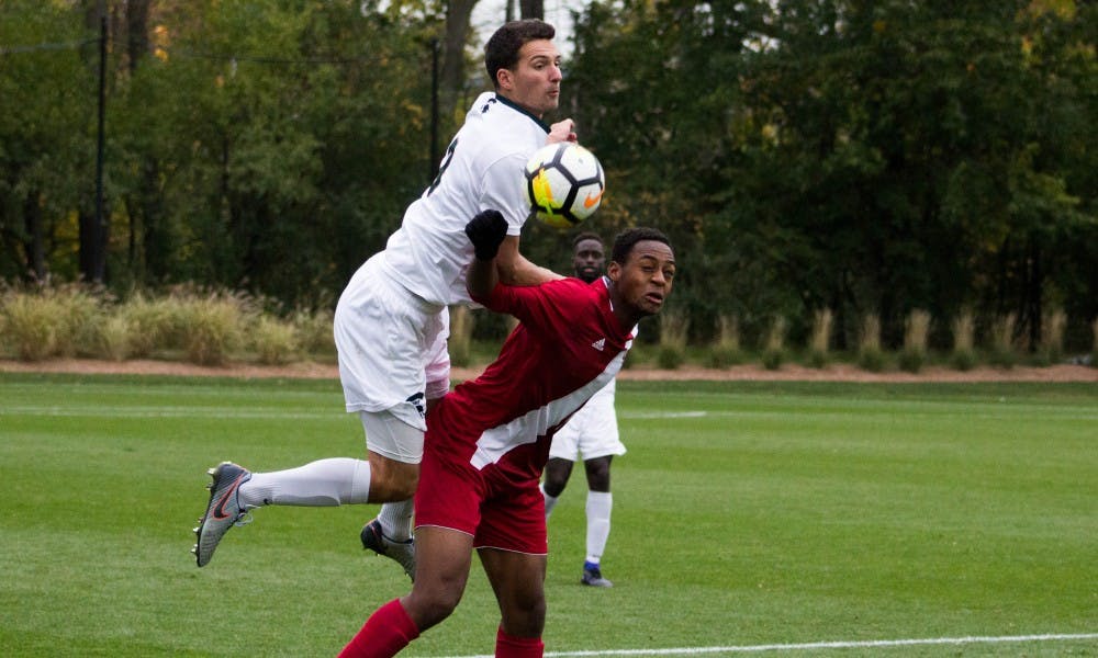 Senior defender Jimmy Fiscus tries to steal the ball from Indiana forward Mason Toye (8)  during the game against Indiana on Oct. 29, 2017, at DeMartin Stadium. The Spartans and the Hoosiers tied 1-1 in double overtime.