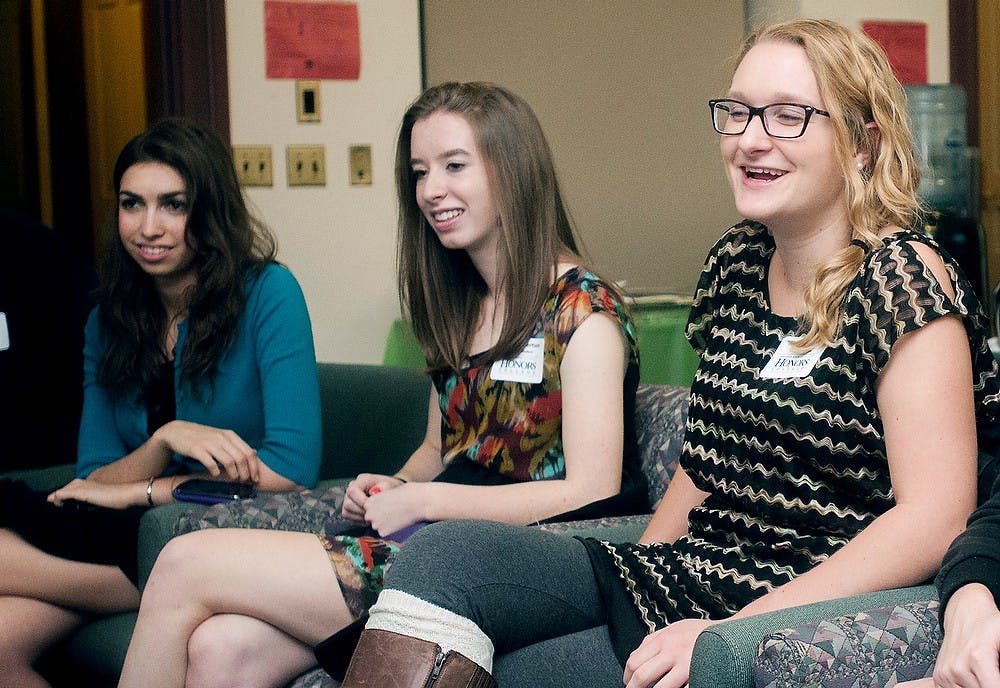 	<p>(Left to Right) Lyman Briggs freshman Julia Simon, Lyman Briggs freshman Laura Robertson and no-preference freshman Ashley Thomas laugh as they introduce themselves at the 12th Annual Honors College Welcome Dinner on Monday Oct. 15, 2012, at Eustace-Cole Hall. Katie Stiefel/ State News</p>