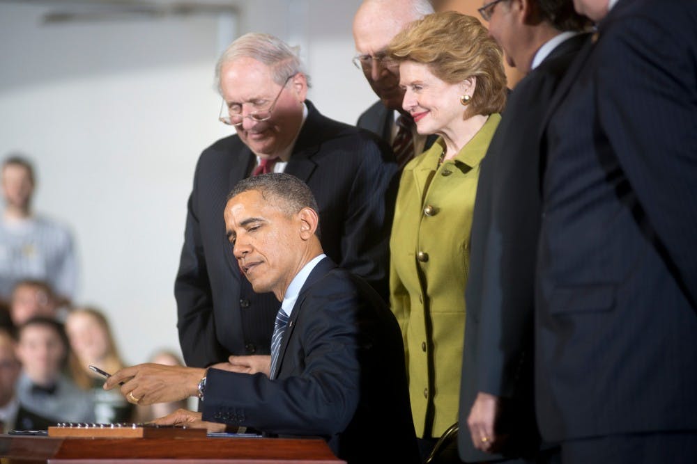 	<p>President Barack Obama signs the farm bill into law on Feb. 7, 2014, at the Mary Anne McPhail Equine Performance Center. Direct crop payments are replaced by an insurance program in the farm bill. Julia Nagy/The State News</p>