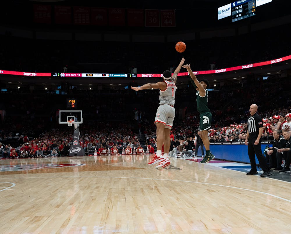 OSU guard Roddy Gayle Jr. (left) attempts to block a shot by MSU guard Jaden Akins at the Schottenstein Center in Columbus, Ohio on Sunday, Feb. 12, 2023. Akins netted 8 shots to Gayle Jr.'s 5.