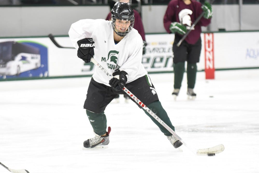 Sophomore forward Kelsey Jaeckle looks to pass the puck to her teammate during practice on Jan. 12, 2017 at Munn Ice Arena. Jaeckle is playing as a defenseman on the USA Team for the World University Games in Kazakhstan later this month.