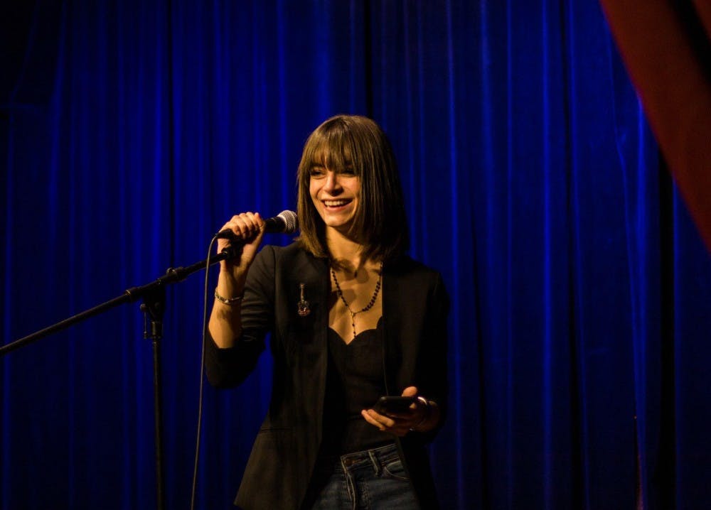 <p>Michigan State arts and humanities senior Grace Carras speaks at the Poetry Room, an open mic event for aspiring poets in the Lansing area. Carras is one of eight winners in Lansing's Sidewalk Poetry Contest. <strong>Photo courtesy of Xavier Cuevas.</strong></p>