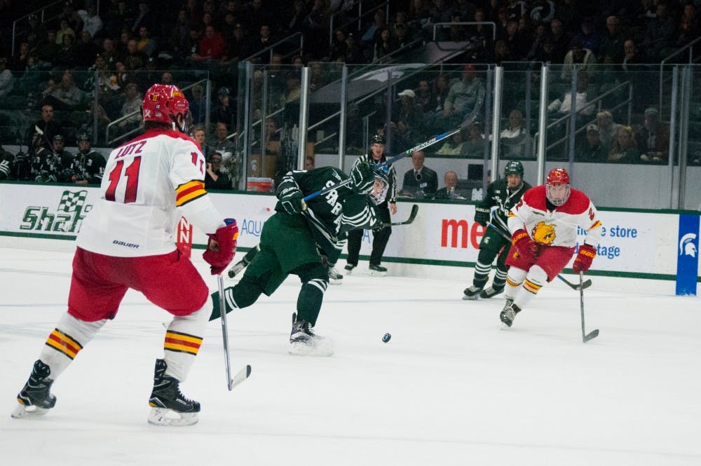 Freshman defenseman Jerad Rosberg (57) misses the puck while taking a shot during the game against Ferris State on Nov. 11, 2016 at Munn Ice Arena. The spartans were defeated by the bulldogs, x-x. 