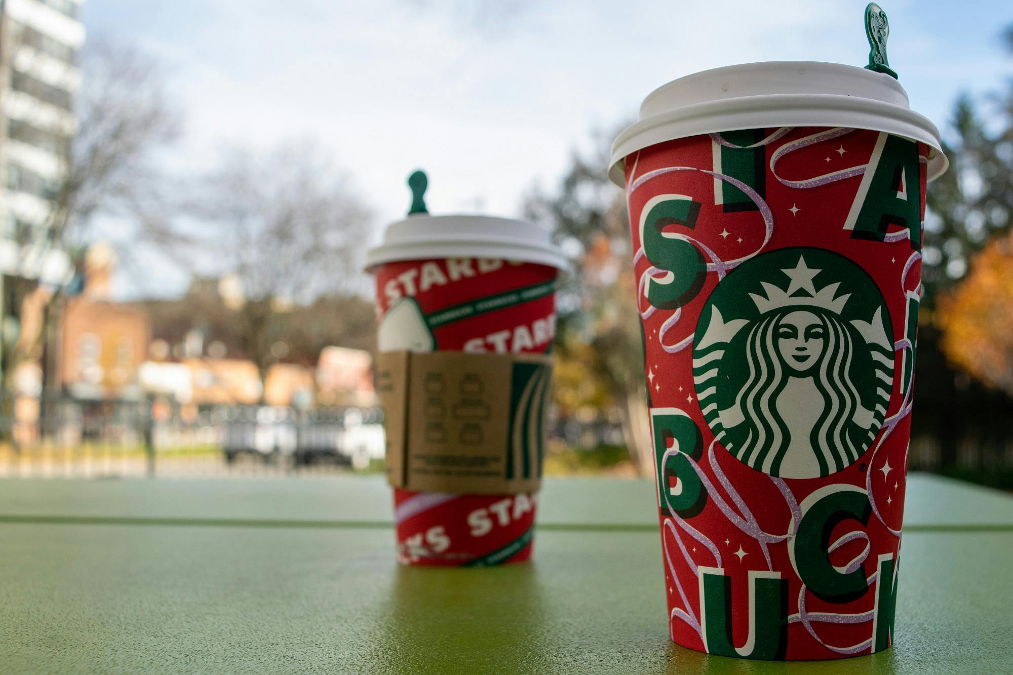 <p>Two of the four Starbucks 2021 holiday cups outside of the MSU Union. </p>