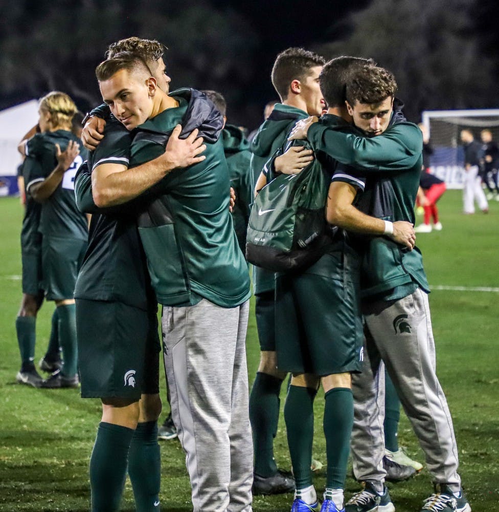 Spartan Players hug eachother after the game against Akron on Dec. 7, 2018 at Harder Stadium. The Spartans fell to the Zips 5-1.