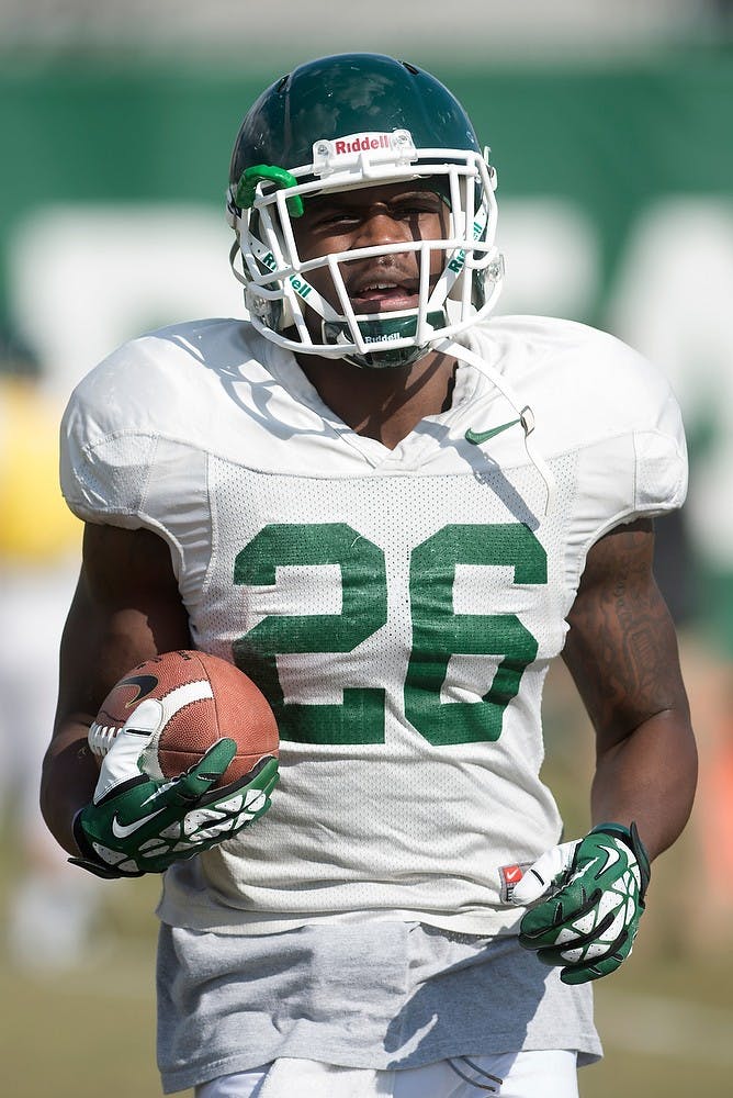 <p>Junior safety R.J. Williamson runs during football practice April 8, 2014, at the practice field outside Duffy Daugherty Football Building. Julia Nagy/The State News</p>