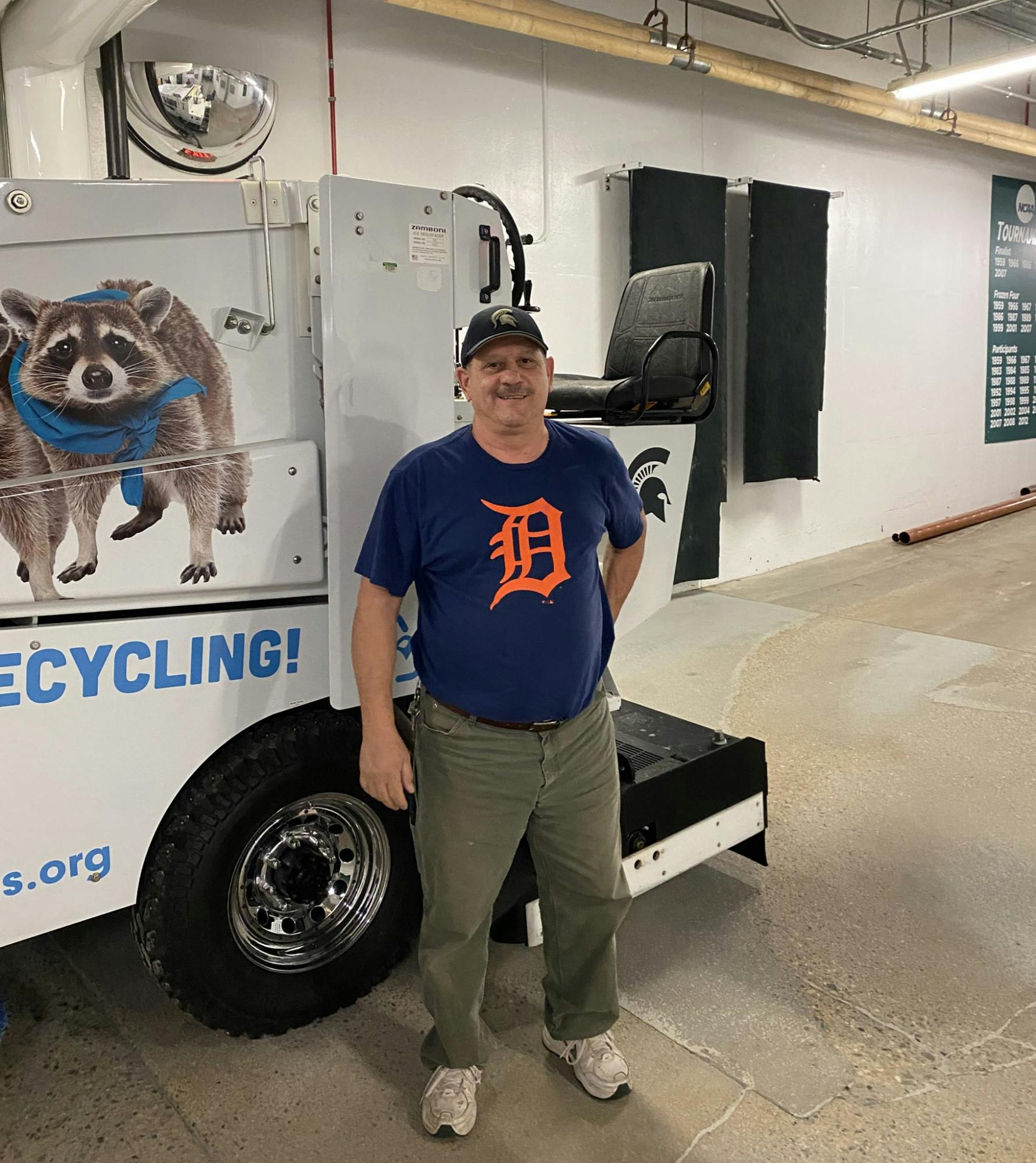 Lou Tomo stands in front of the Zamboni he operated for the past 35 years at Munn Ice Arena on Aug. 27, 2020. Photo courtesy of MSU Hockey 